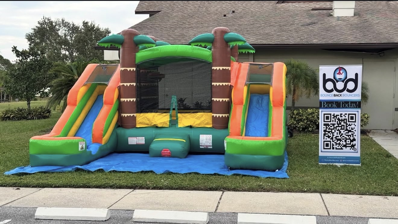 Tropical combo bounce house with dual slides set up for a Tampa Bay party