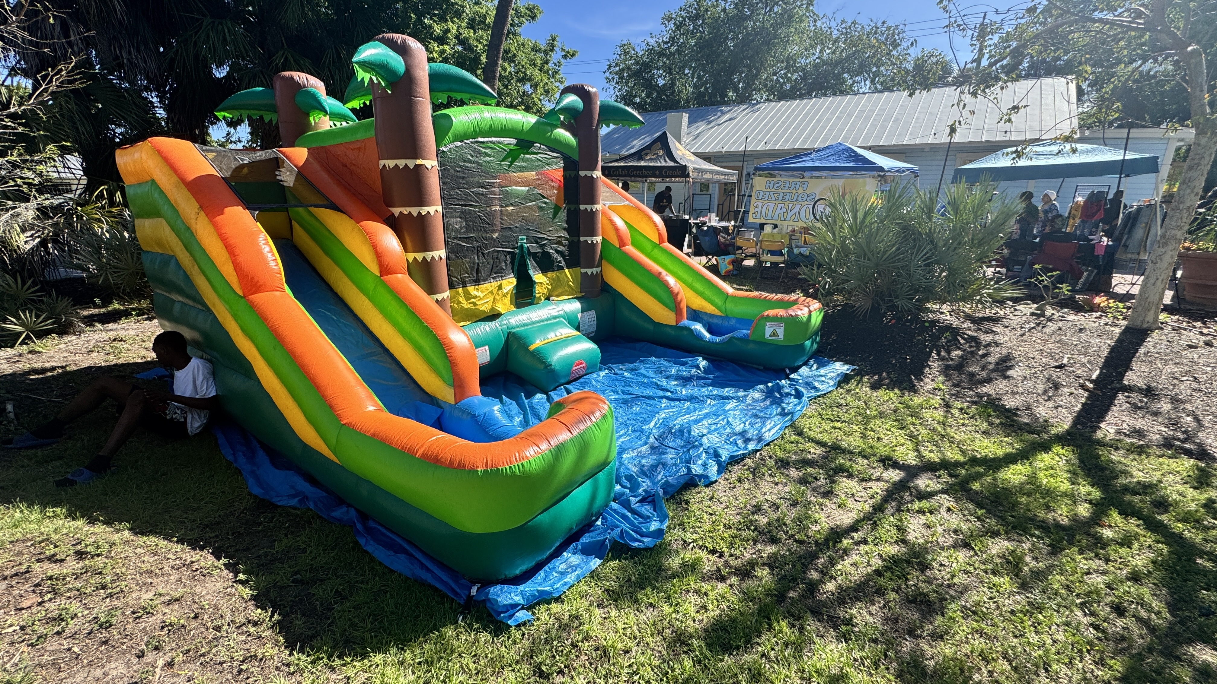 Tropical combo bounce house with slide at a Tampa Bay community festival